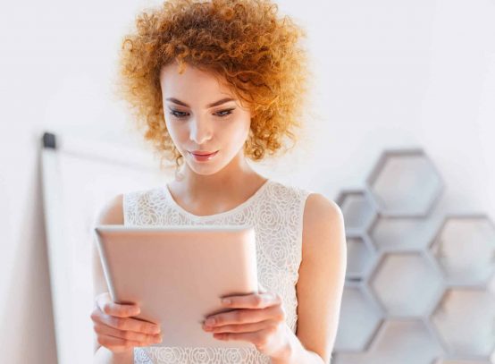serious-business-woman-using-tablet-in-office-P6BLPMA-scaled.jpg